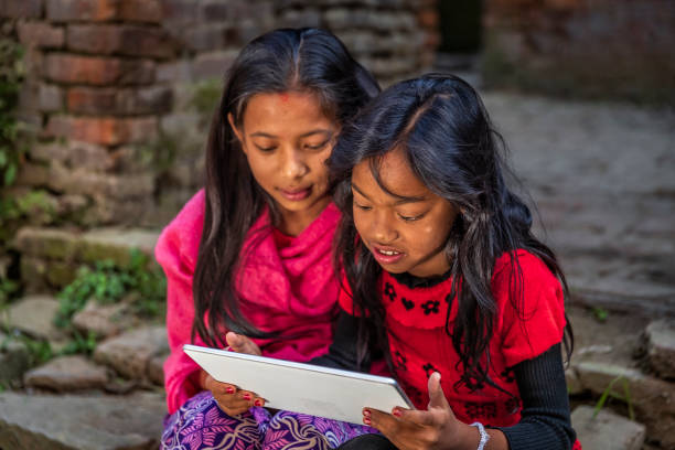 istock Two young Nepali girls using a digital tablet in Bhaktapur, Nepal 1500695234