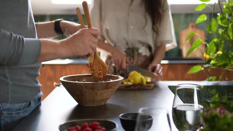 Couple preparing food together at kitchen