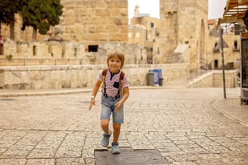 European tourist family with children, visiting Jerusalem, meeting new culture