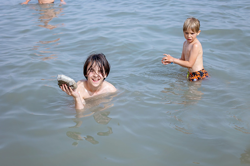 Child, boy, floating in the Dead sea on a very hot summer day
