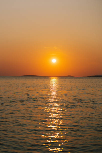 istock Sunset over calm sea and tranquil sky 1500707081