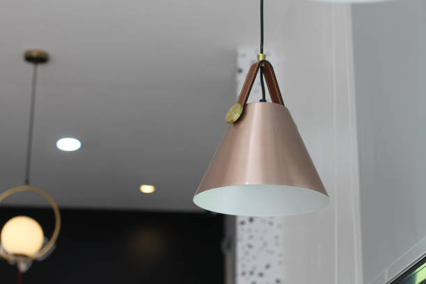 istock A cream-colored cone lamp hangs from the ceiling to provide light. 1500707118
