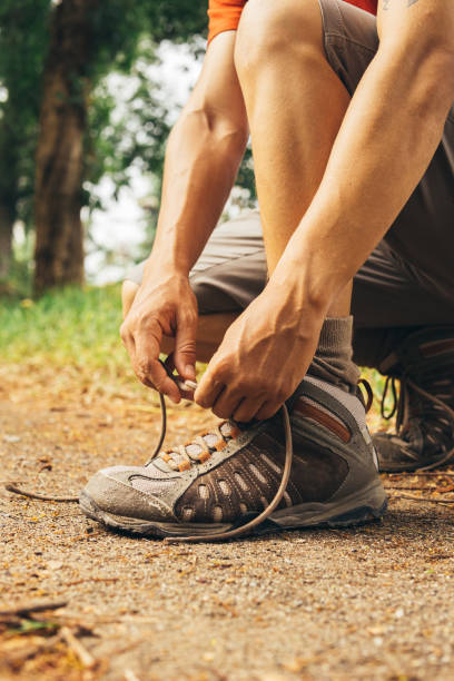 istock Hiker tying shoe laces in the mountain 1500720978