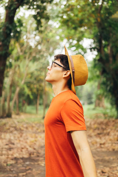 istock Young man breathing deep fresh air outdoor. 1500721072