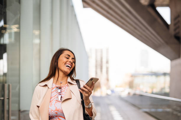 istock Business woman laughing using smartphone 1500722725