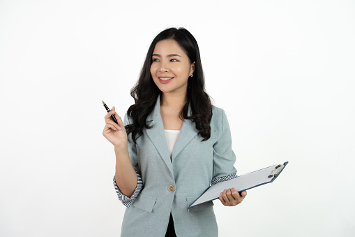 Portrait happy beautiful young asian business woman long hair standing and holding clipboard with looking to camera and smile over white background.