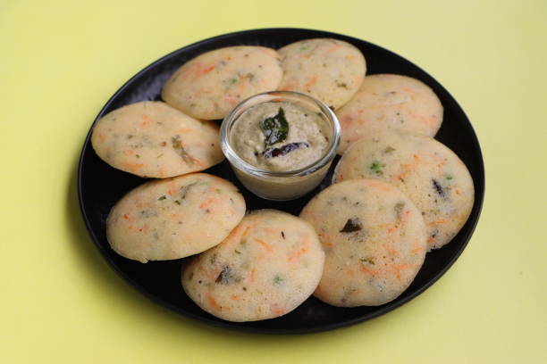 Rava Idli or semolina idli or steamed cakes made with semolina, yogurt, spices, veggies, an Indian breakfast Rava Idli or semolina idli or steamed cakes made with semolina, yogurt, spices, veggies, South Indian breakfast rawa island stock pictures, royalty-free photos & images
