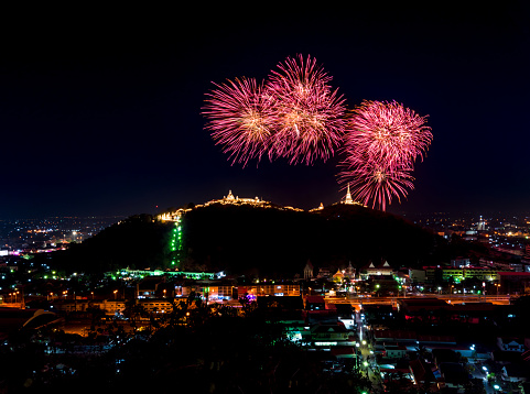 The most famous firework Pra Nakorn Kiri festival in Petchaburi Thailand. Fireworks display over three pagodas on Khao Wang hill at night.