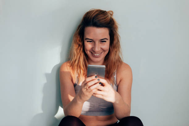 istock satisfied woman after workout studies her biometric data on smartphone 1500737282