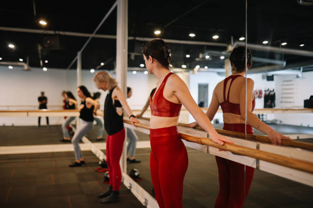 istock group of women exercising on the barre class 1500744453
