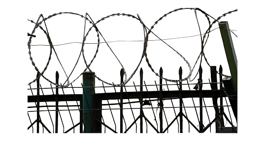 Barbed wire and iron fence\n isolated on a white background.