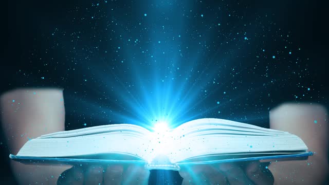 Magic Book on Magician Hand I Dark Background with Glowing Light Rays. The Fairy Tales and Magical Knowledge Concept