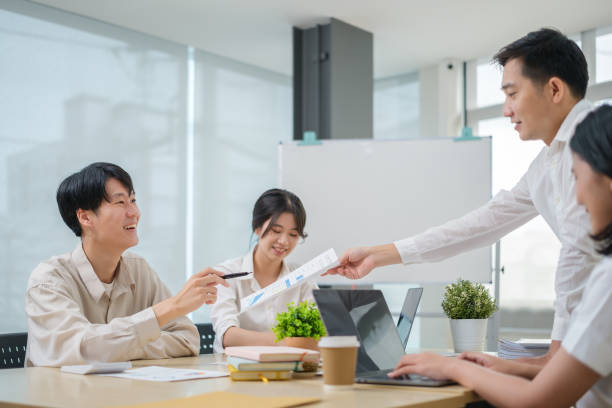 istock Business colleagues discussing financial data, working together in bright workplace. 1500748497