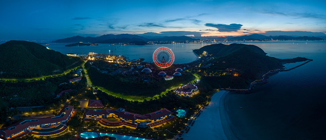 Drone view Hon Tre island in sunset with sky ferris wheel - Nha Trang city, Khanh Hoa province, central Vietnam