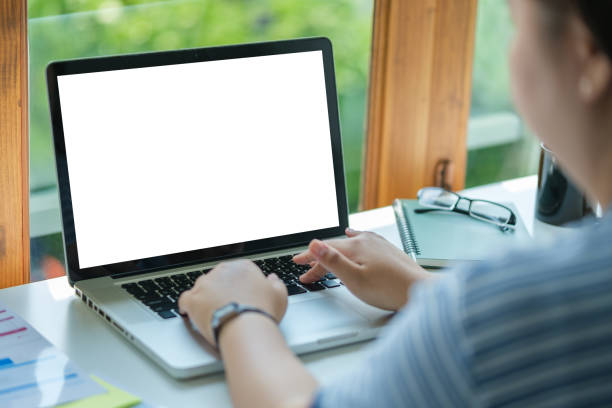 istock Over shoulder view of male freelancer working online, typing email on laptop computer. 1500750575