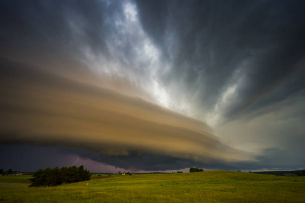 Angry supercell storm influenced by Climate change. Dangerous storm supercell shelf cloud with layers. High quality photo