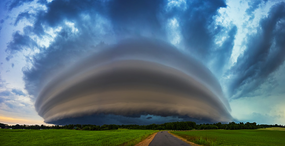 Angry supercell storm influenced by Climate change. Dangerous storm supercell shelf cloud with layers. High quality photo