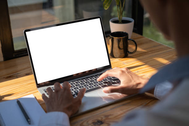 istock Businessman checking news, typing email on laptop computer. Over shoulder view. 1500760311