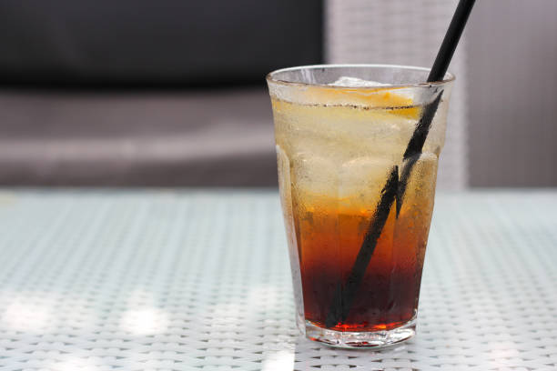 istock ice lemon tea with a black straw on the table. blurred background. copy space. 1500760389