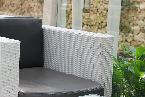 white synthetic rattan chair with gray seat in cafe.