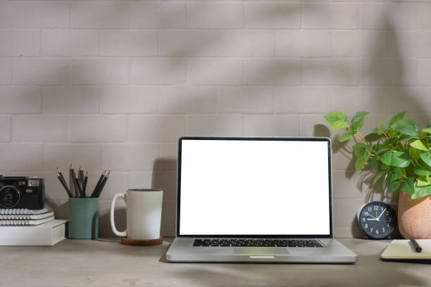 istock Laptop computer with blank display, coffee cup, houseplant and stationery on grey table. 1500762883
