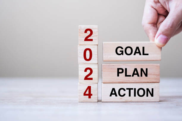 istock hand holding wooden block with text 2024 GOAL, PLAN and ACTION on table background. Resolution, strategy, solution, goal, business and New Year holiday concepts 1500766050