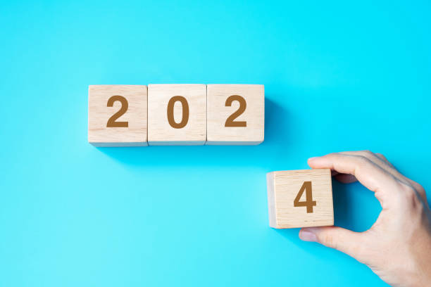 istock hand holding wooden cube block with 2024 text on blue background. Resolution, plan, review, goal, start and New Year holiday concepts 1500766091