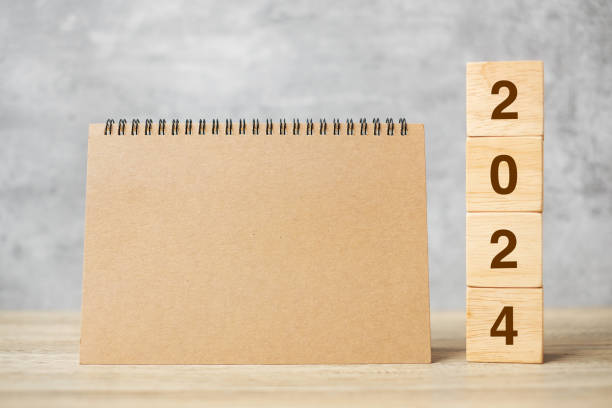 istock 2024 Happy New Year with blank notebook and wooden number. countdown, Resolution, Goals, Plan, Action and Mission Concept 1500766152