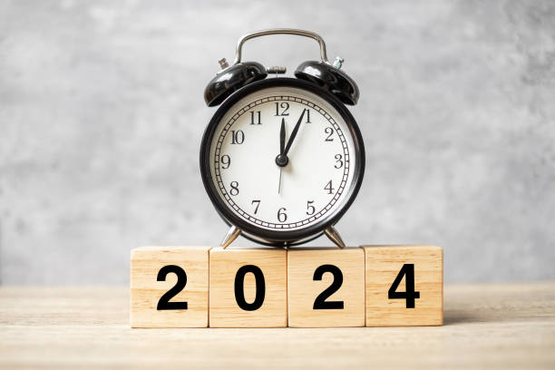 istock 2024 text with clock on table. Resolution, time, plan, goal, motivation, reboot, countdown and New Year holiday concepts 1500766153