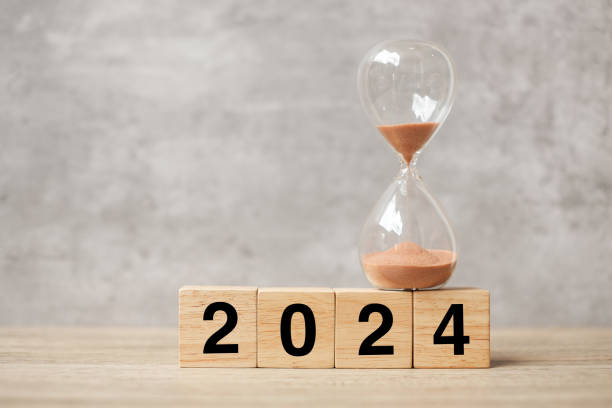 istock 2024 text with hourglass on table. Resolution, time, plan, goal, motivation, reboot, countdown  and New Year holiday concepts 1500766156