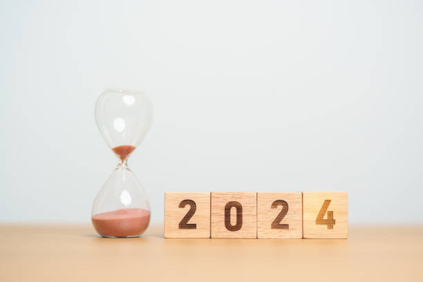 istock 2024 text with hourglass on table. Resolution, time, plan, goal, motivation, reboot, countdown  and New Year holiday concepts 1500766179