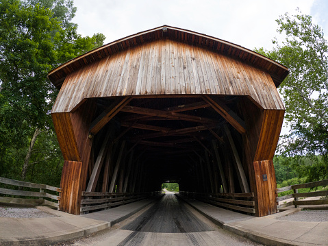 Extra long Clarkson Covered Bridge, near Cullman, Alabama, covered Crooked Creek.  Wooden bridge has tin roof.