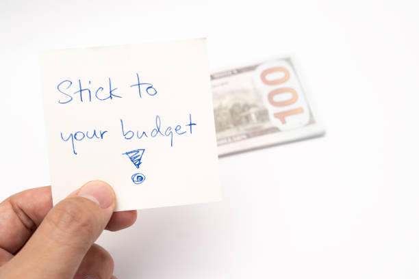 istock Dollars cash money with text written note STICK TO YOUR BUDGET. 1500770121
