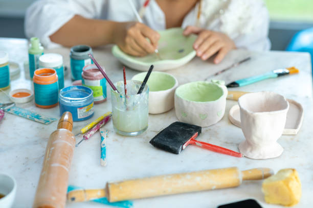 istock Ceramist girl decorating ceramic 1500782160