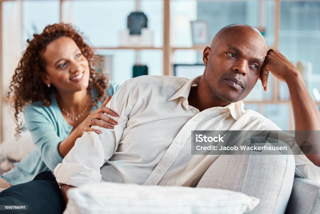 Comfort, fight and couple on sofa for marriage problems, frustrated and depression in living room. Bad communication, relationship and woman with angry man on couch for fighting, argument and divorce Couple - Relationship Stock Photo