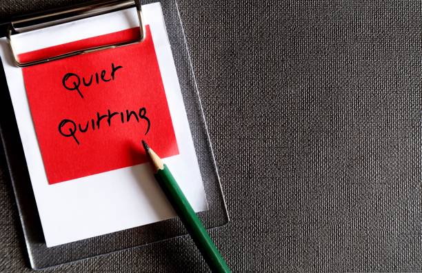 istock Wall paper copy space background, red note with handwritten text QUIET QUITTING - concept of doing only what job demands and nothing more, not taking corporate job too seriously 1500787384