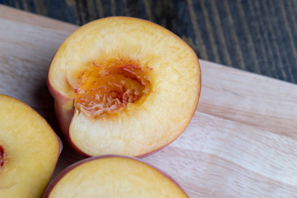 istock Ripe fresh peaches on a wooden table 1500789745