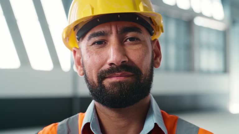 Face, construction worker and man with confidence on site, building project or success in industrial development. Portrait, architect or contractor with smile for work, job and engineer working