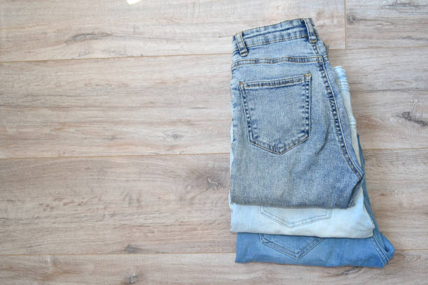istock three pairs of jeans lie on the floor 1500792243