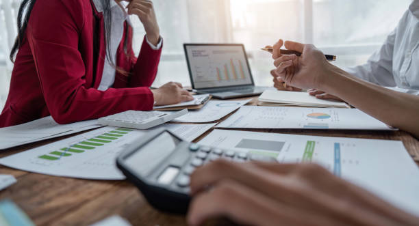 istock Team Of Business working at office with documents on his desk, doing planning analyzing the use a financial calculator, business plan investment, finance analysis concept 1500792531