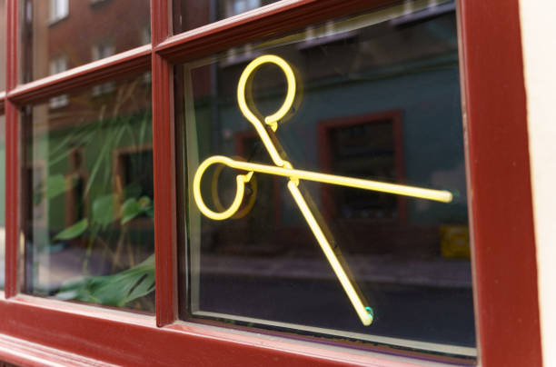 Vintage retro window with neon scissors in a barbershop.