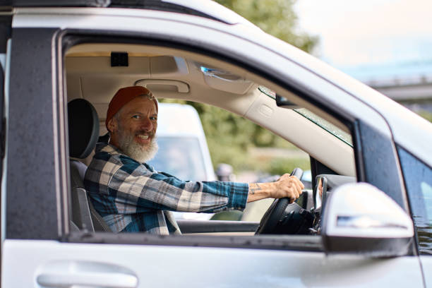 istock Happy older man driving camper van sitting inside, campervan rentals. 1500793830