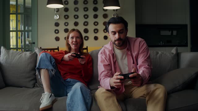 Man and woman play video games at home
