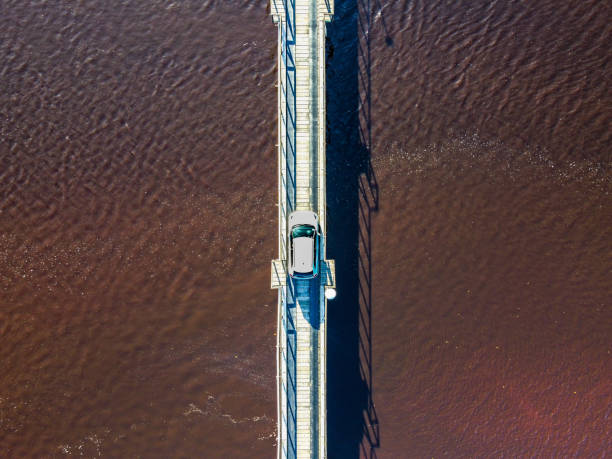 istock White car driving over small wooden coastal bridge. 1500794840