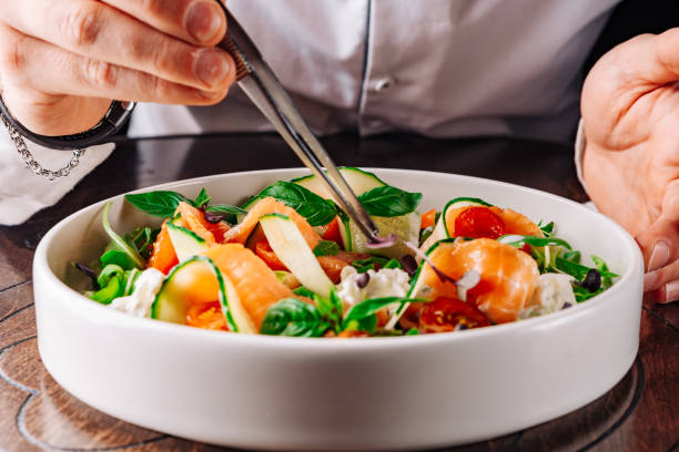 istock chef hand decorated smoked salmon salad with cucumbers, cream cheese, arugula 1500794953