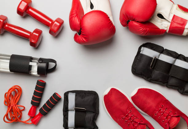istock Red sport equipment on color background, top view 1500797955