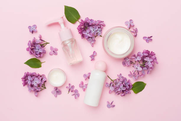 istock Composition with cosmetic bottles and flowers on color background, top view 1500798427