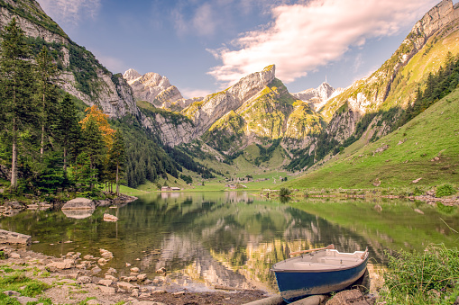 Seealpsee in the Swiss Alps with a boat and a view of the Säntis