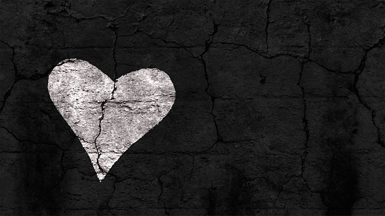 One white coloured textured heart over a black old weathered horizontal background. Blank copy space all around the heart. Apt for love Greeting card, with copy space for text. There is No text, No people but empty copy space for text.