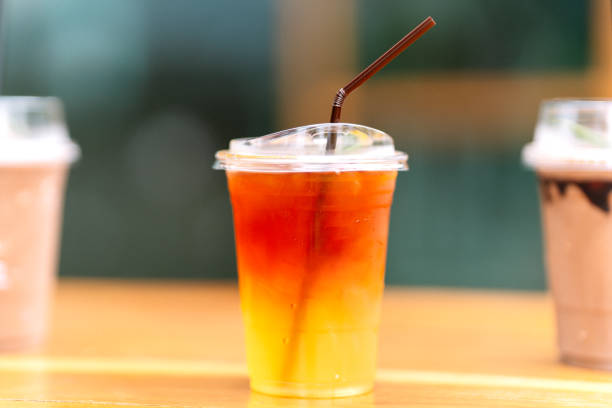 istock Lemon tea in a plastic glass with straws on the table. 1500799936